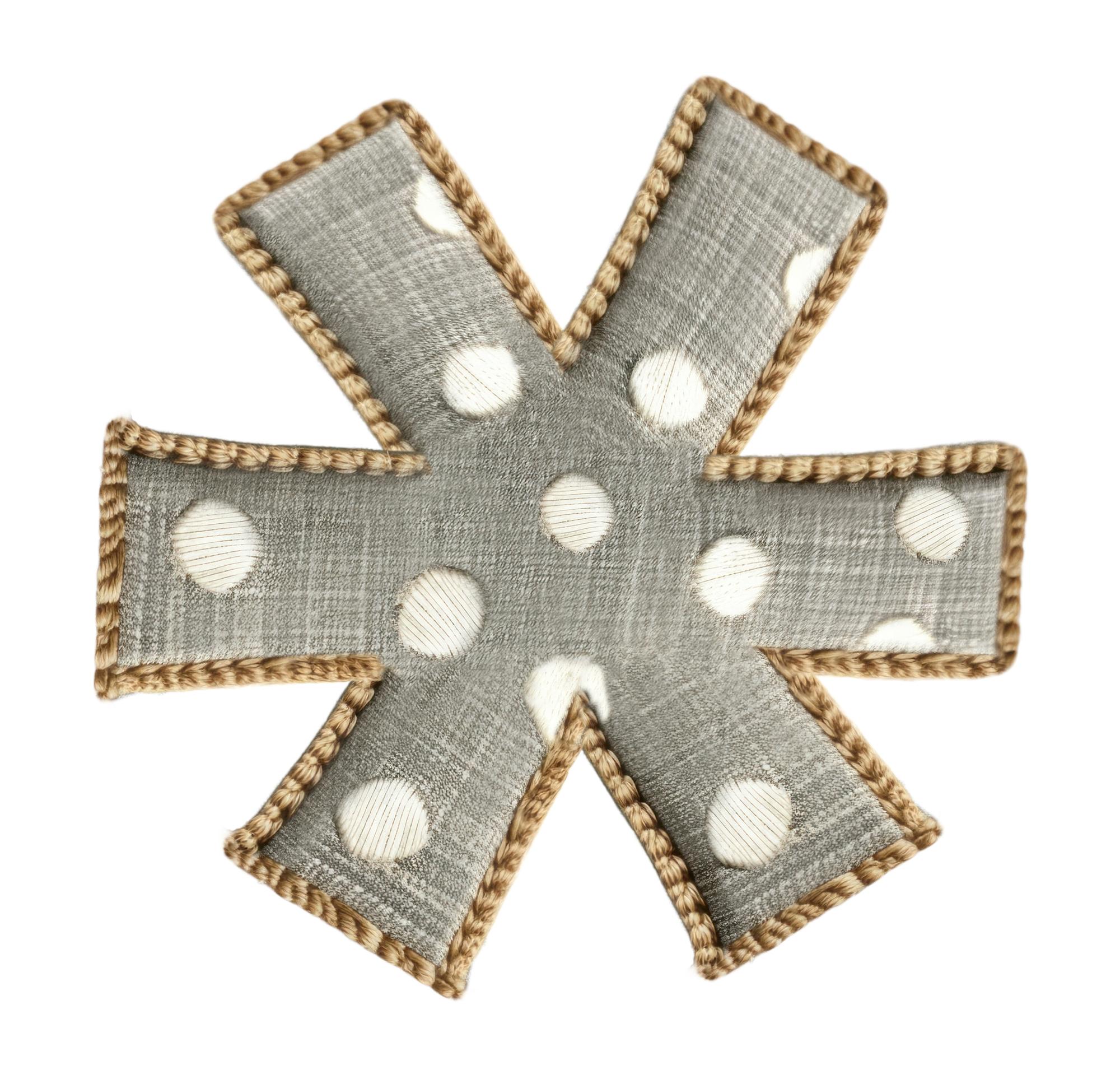 Stack of finished embroidered patches in neutral tones